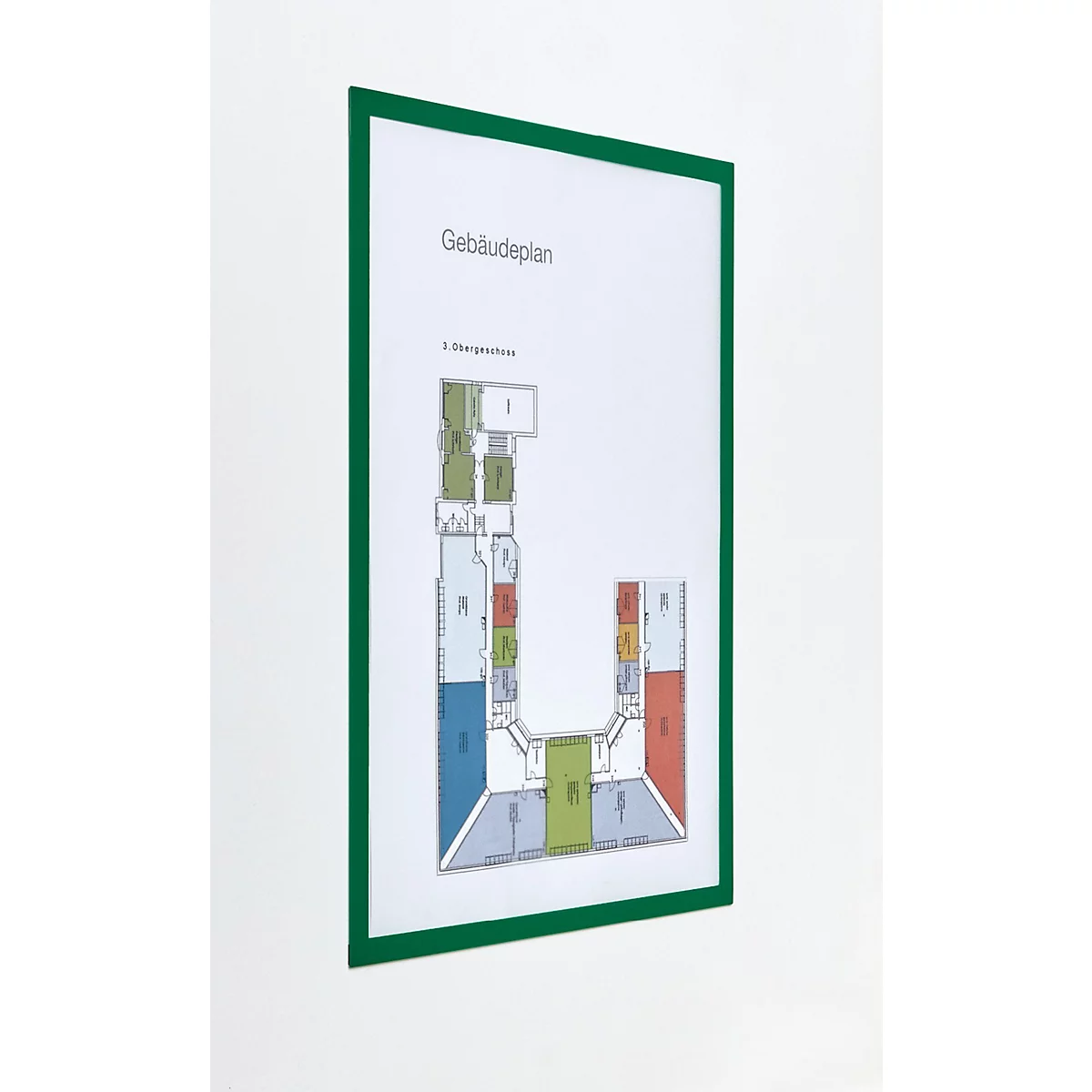 Ein grüner Klapprahmen an einer Wand mit einem Gebäudeplan, daneben Werbetext und das Logo von magnetoplan.