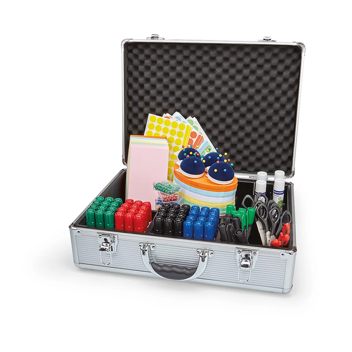 Open silver suitcase filled with school supplies. Contains papers, pincushions, markers, scissors, and glue.