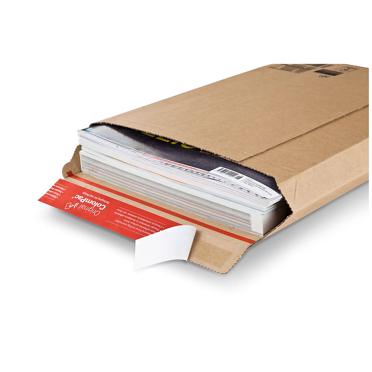 A brown shipping box partially open with magazines inside. A red sticker with white text is visible.