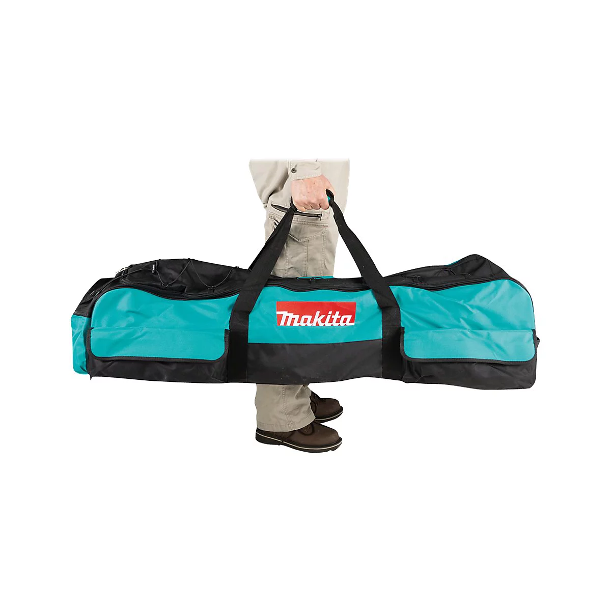 Person trägt eine lange, türkisfarbene Makita-Werkzeugtasche am schwarzen Tragegriff.