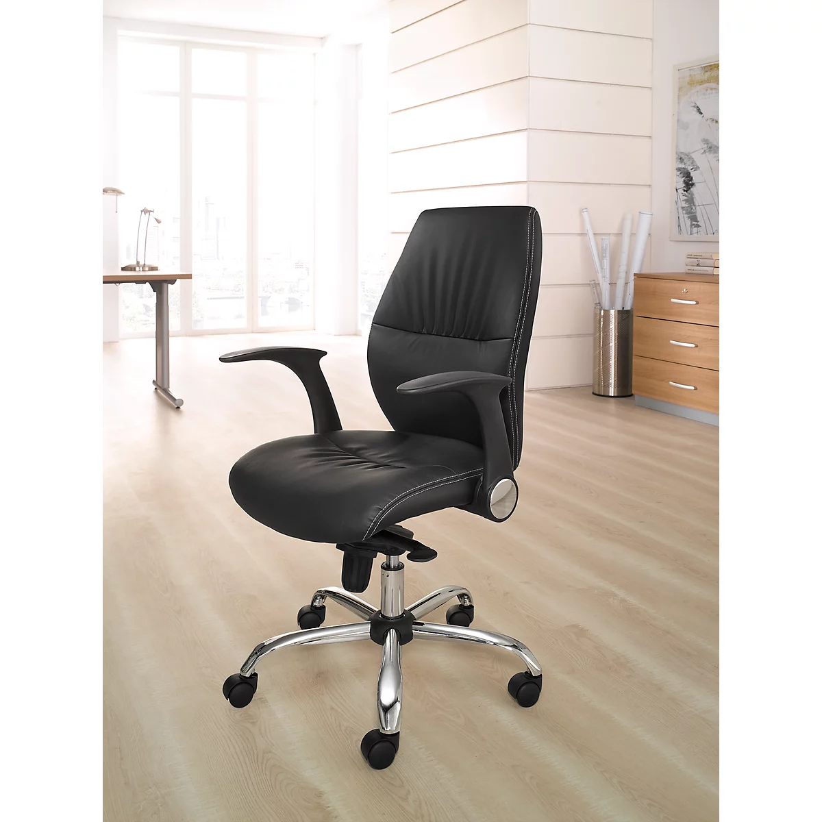 Black office chair against a light background. Chrome frame, armrests and backrest made of leather.