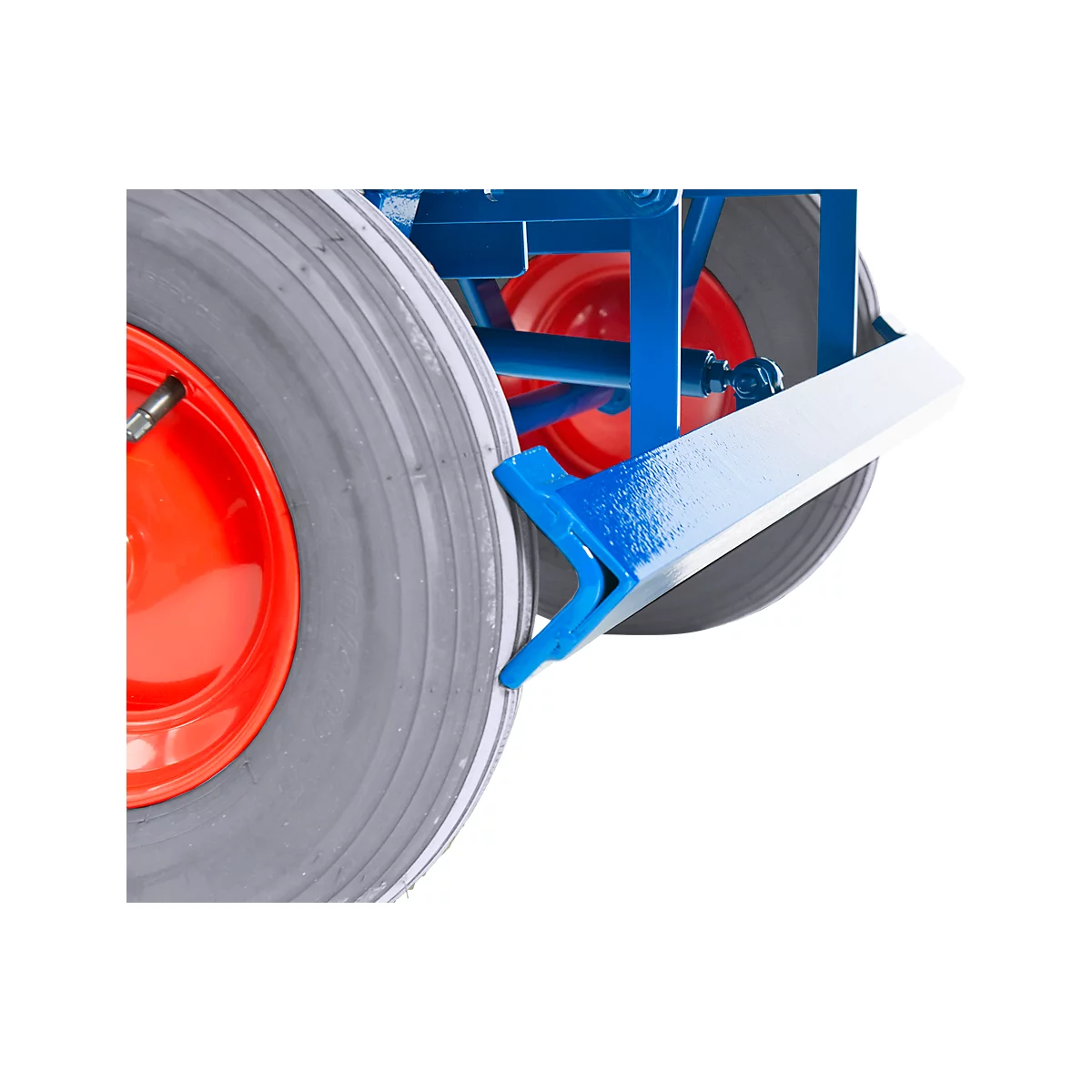 Close-up of a blue and white painted metal part attached to a gray tire. Red rim edge.