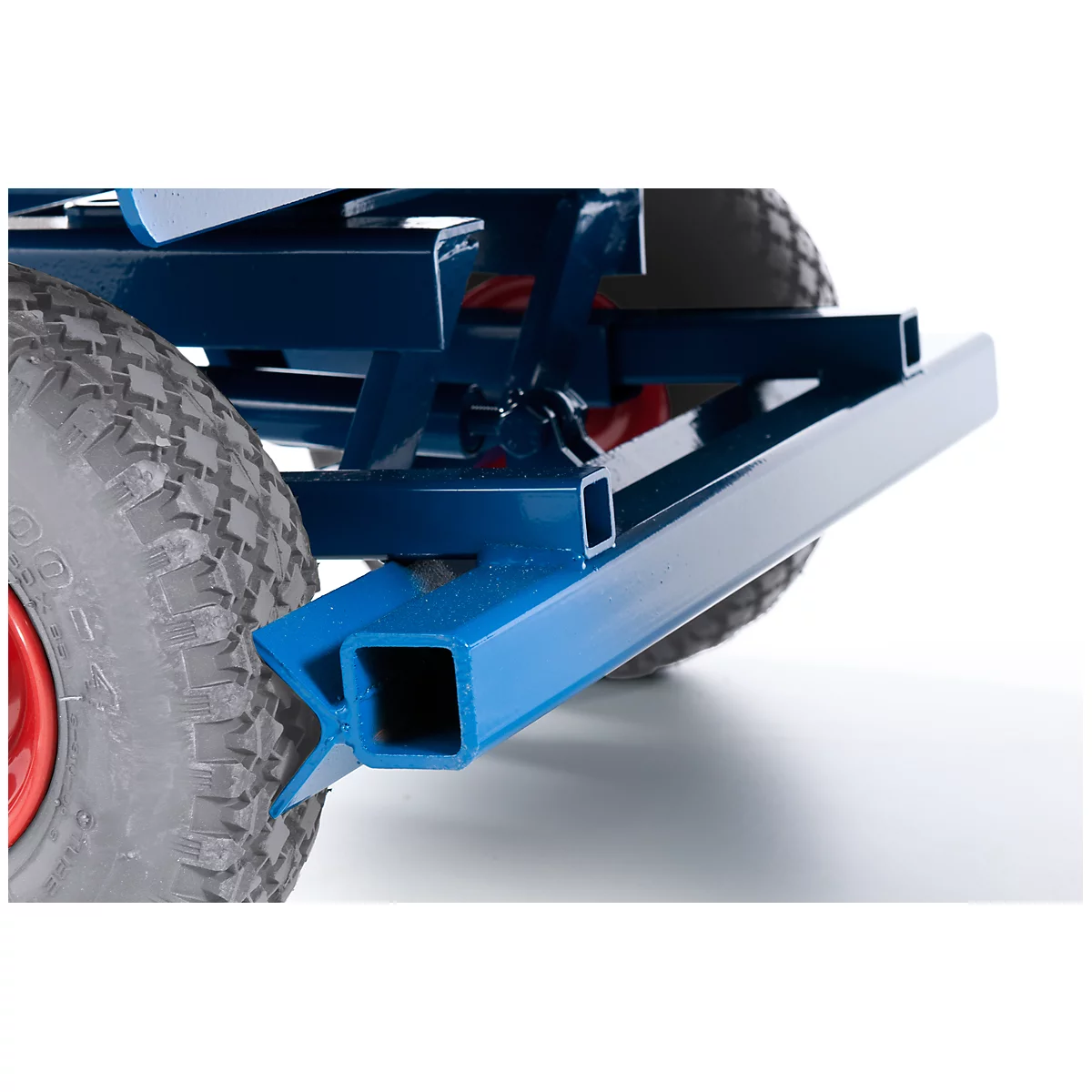 Close-up of a blue metal frame with a wheel in the background. A red circle is visible in the wheel.