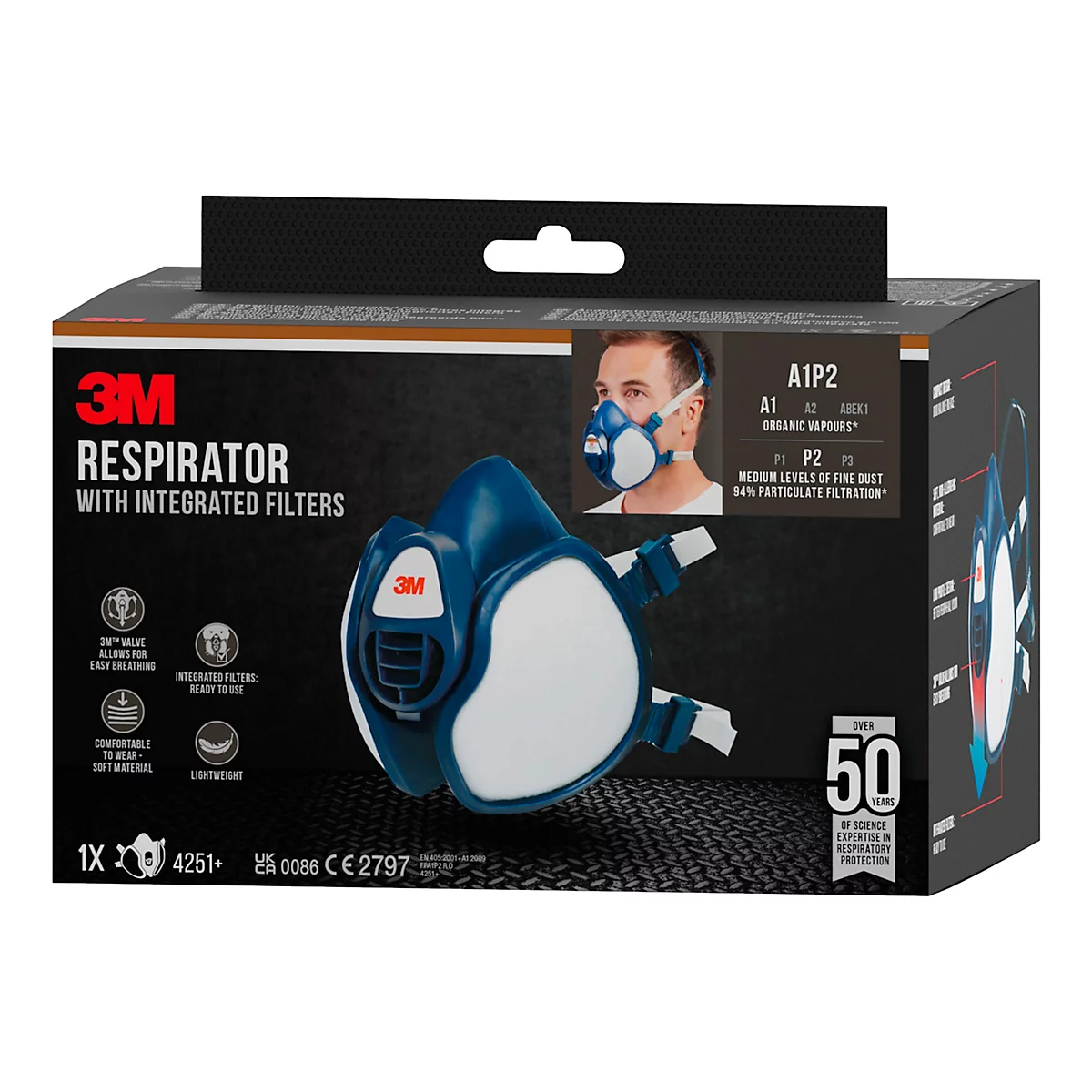 Masque respiratoire 3M, bleu et blanc, avec filtres intégrés, image du produit sur l'emballage.