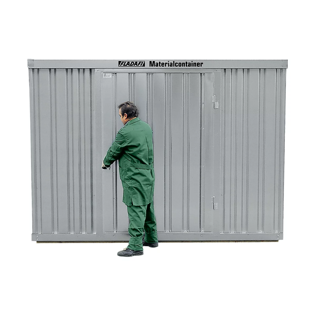 A man in green workwear opens the door of a gray material container. The container has the lettering "FLADAFI Materialcontainer".