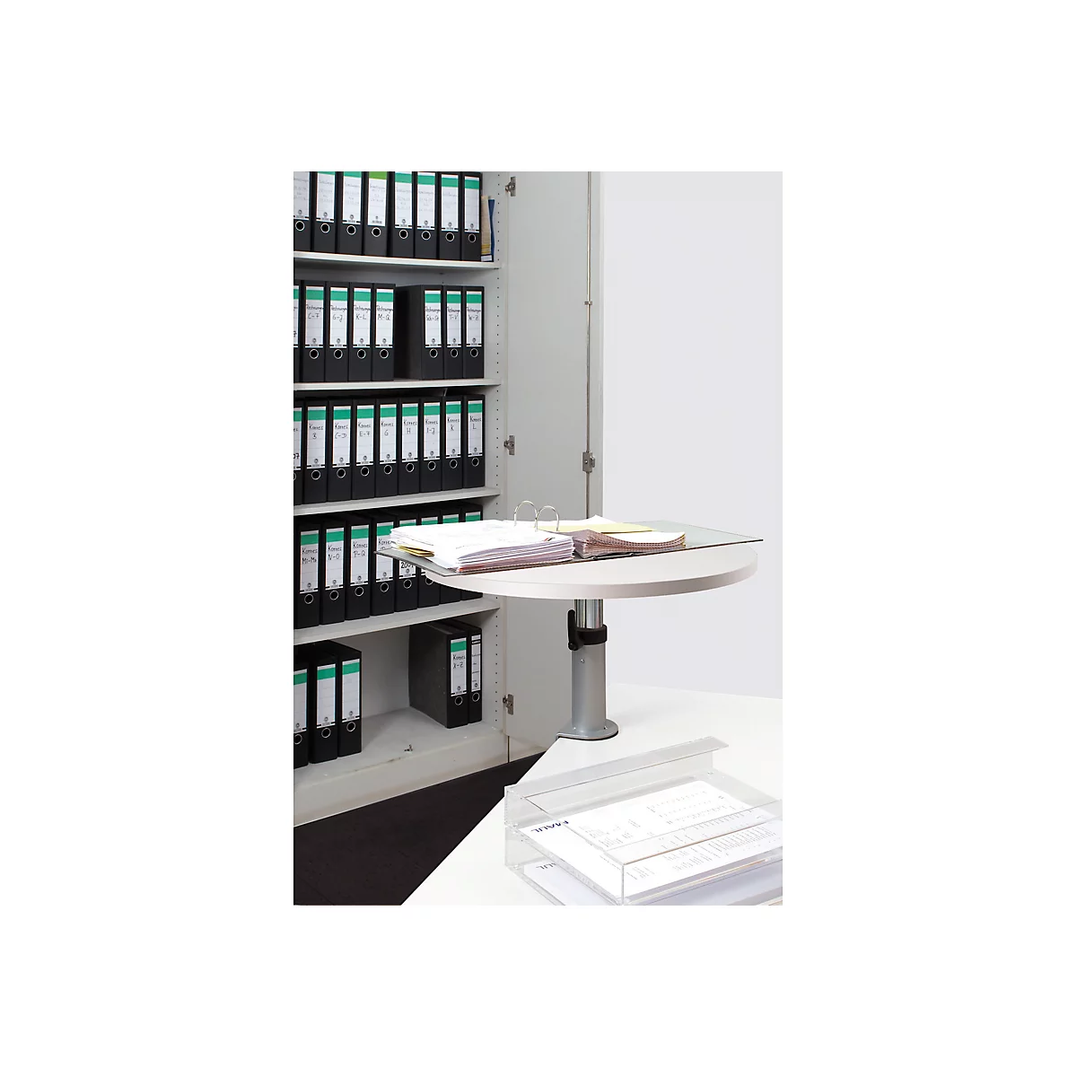 Open filing cabinet with files, round table with files, below a document tray.