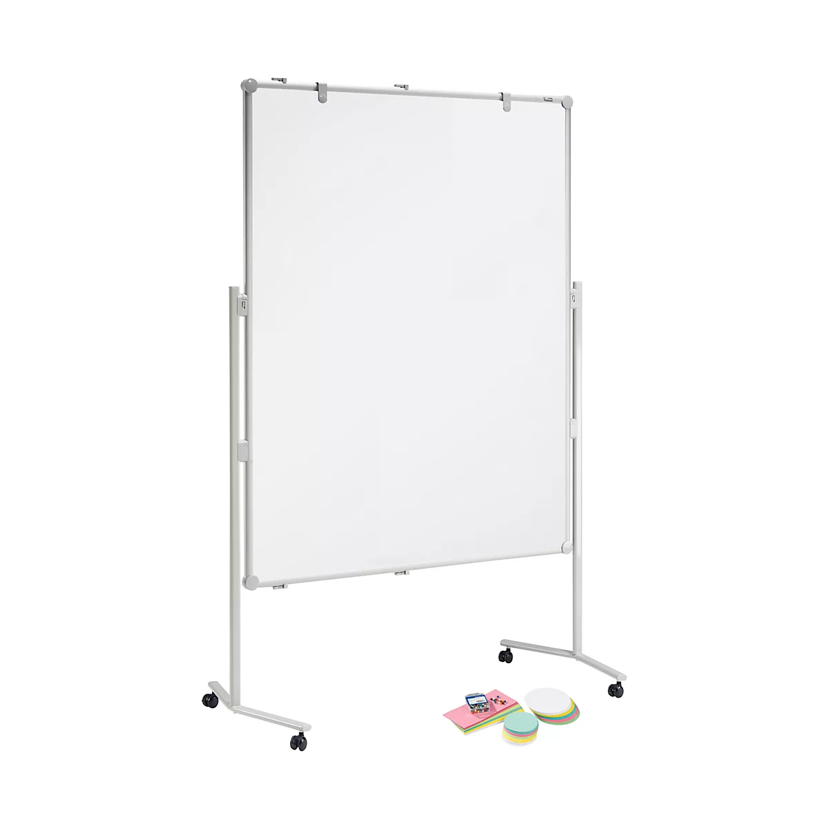 White mobile whiteboard with pen holders and rollers. Beside it are notes, pads, and pens.