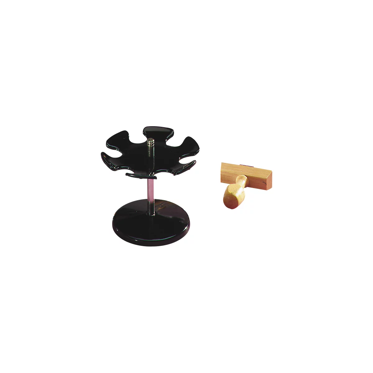 Black pen holder and wooden stamp. The pen holder has a round base, a pink rod, and a flower-shaped holder. The stamp is light.