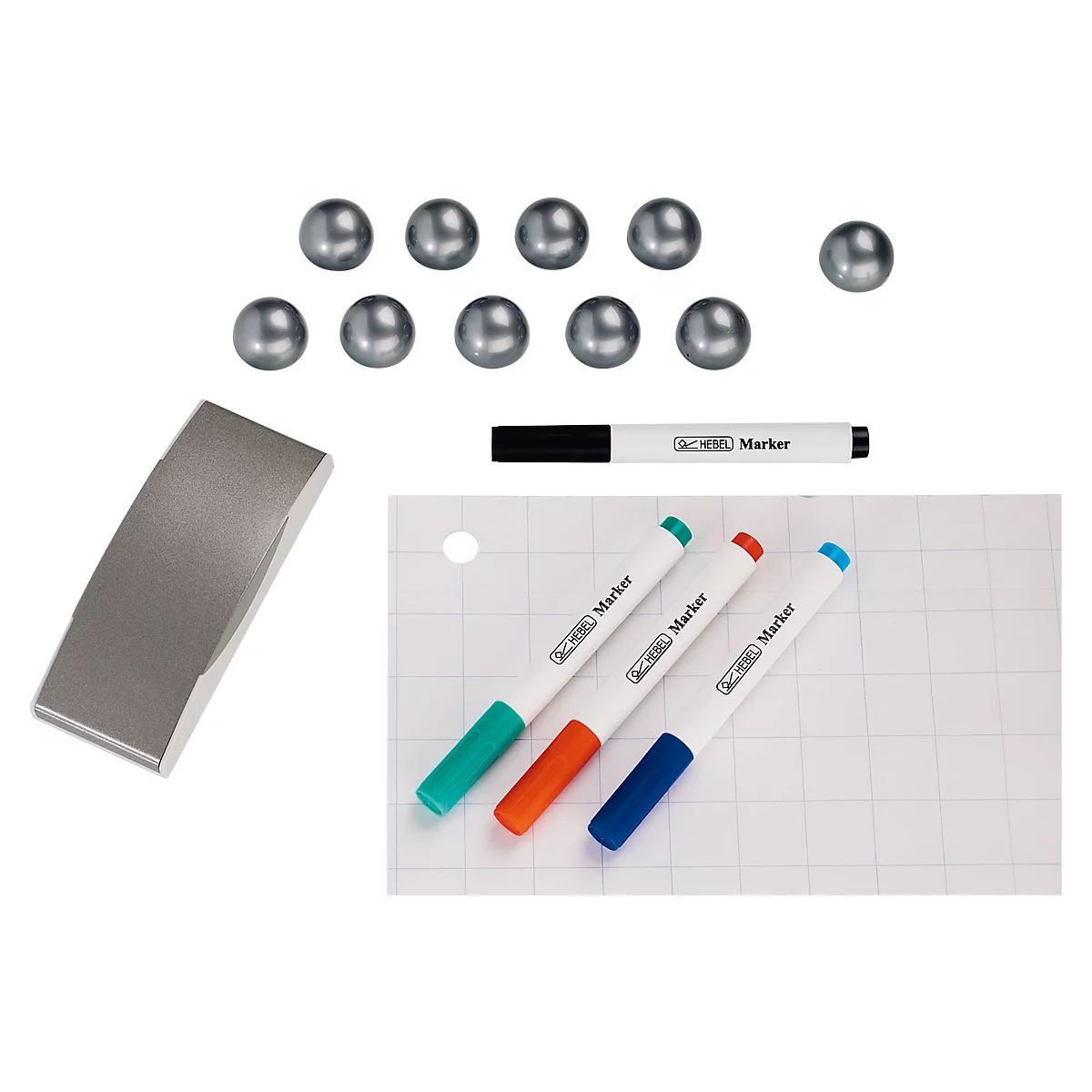 Magnet, spheres, eraser, and colored markers on graph paper. Markers with green, orange and blue caps, one black marker.