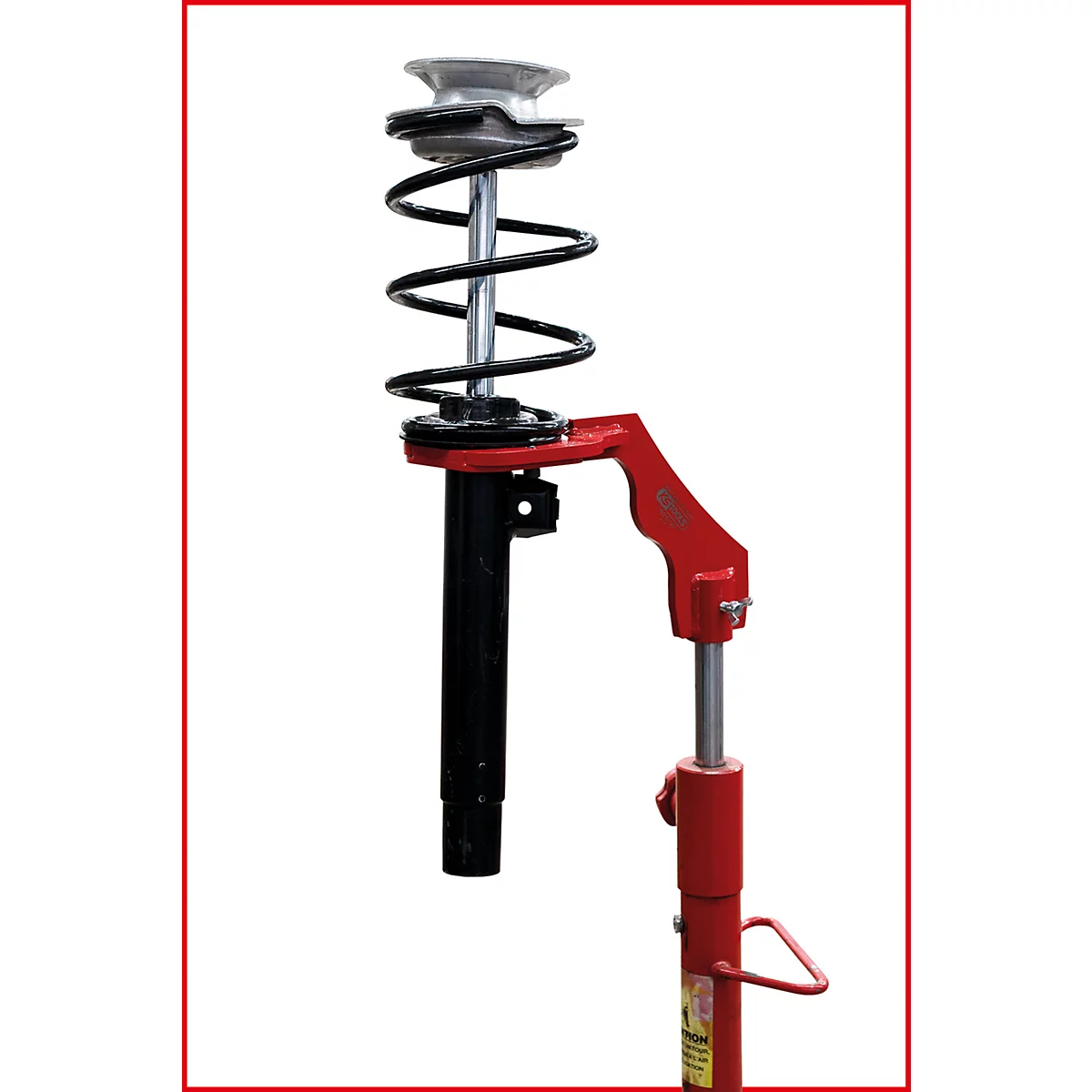 Ein Stoßdämpfer mit Feder und rotem Werkzeug.