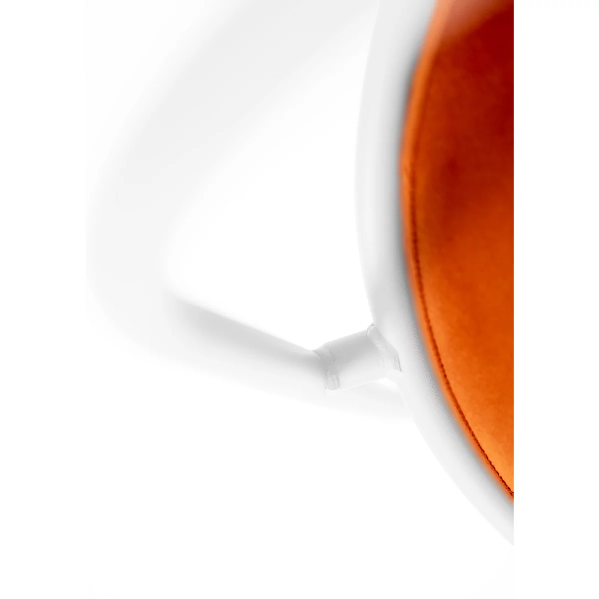 Nahaufnahme einer weissen Kaffeetasse mit orangefarbener Innenseite und weissem Henkel. Der Hintergrund ist weiss.
