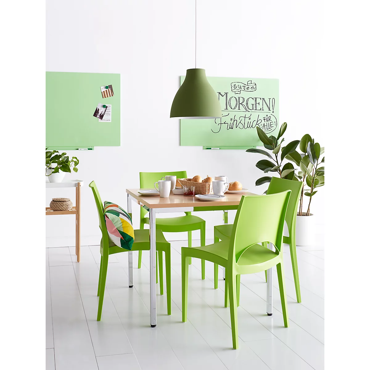 Dining room with green chairs, table, and lamp. On the table: breakfast with the inscription: Good morning!