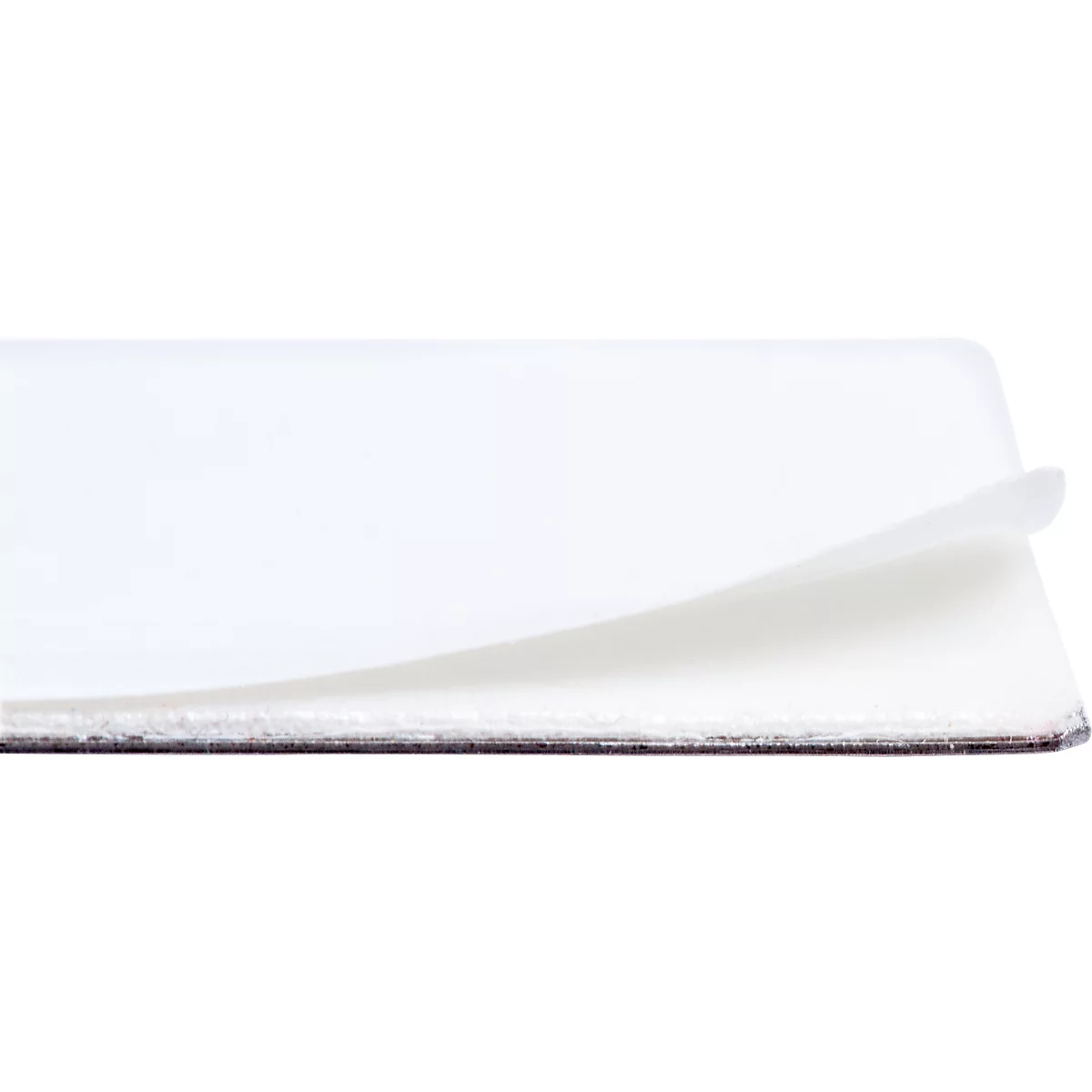 Close-up of a white card, lifting from the edge, showing another card underneath.