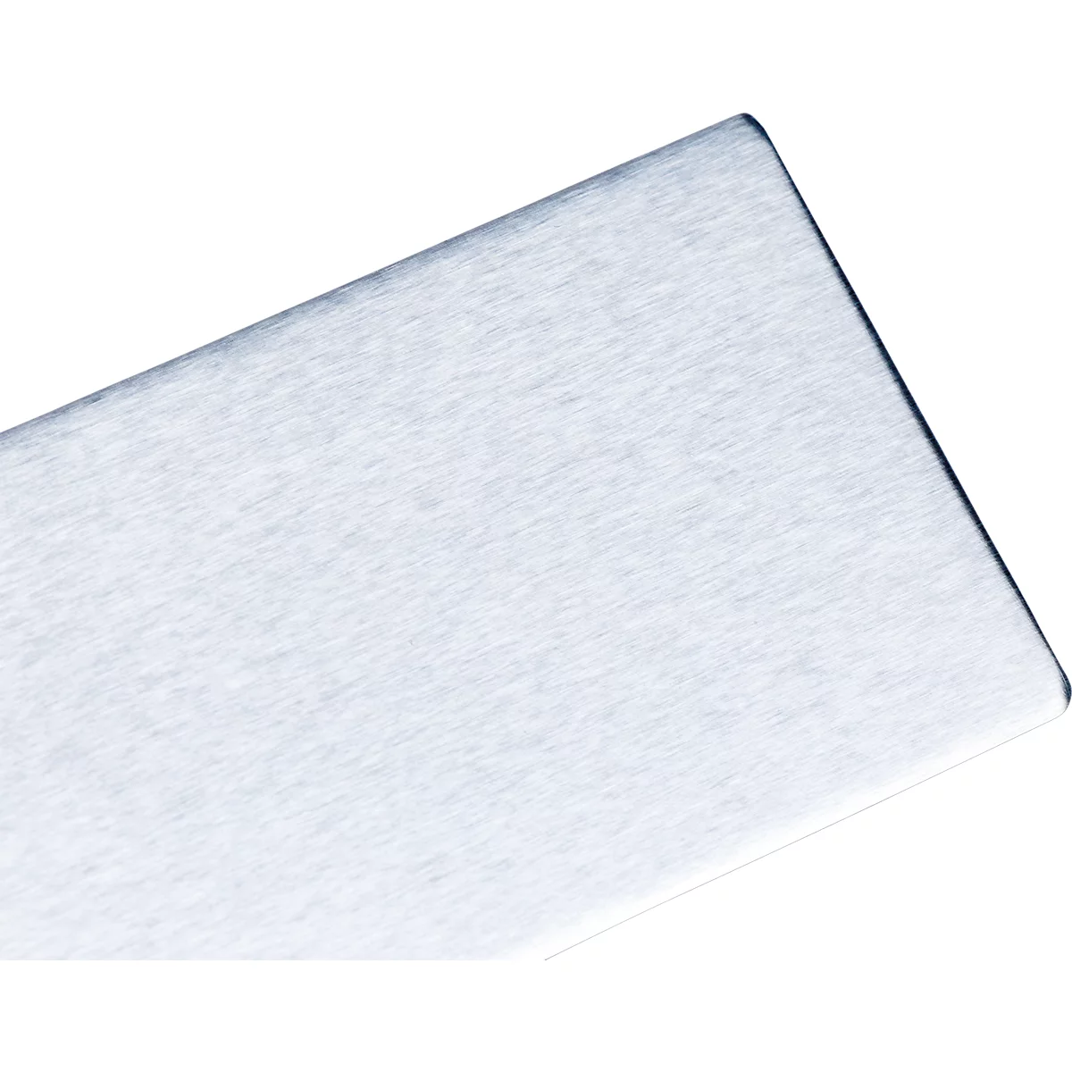 Close-up of a metallic, rectangular object with rounded corners, running diagonally from top right to bottom left.