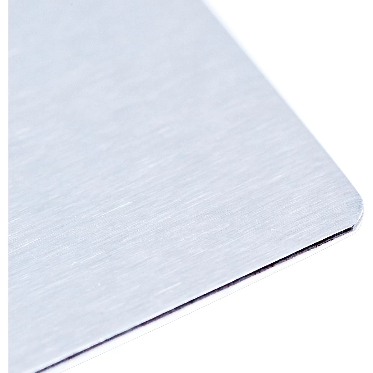 Close-up of a metallic surface with a brushed texture. The edge is rounded and has a dark line.