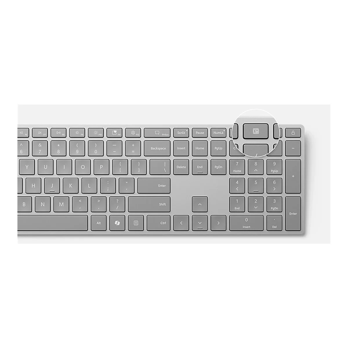 Nahaufnahme einer grauen Computertastatur mit Fokus auf eine spezielle Funktionstaste oben rechts.