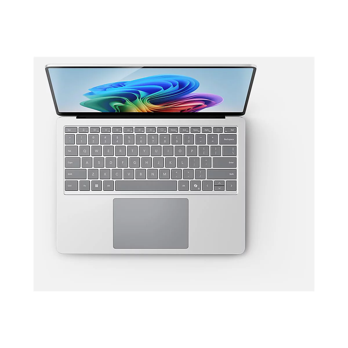 Ein Laptop, von oben gesehen, liegt auf weiÃŸem Untergrund. Das Display ist geÃ¶ffnet und zeigt ein farbenfrohes Hintergrundbild.