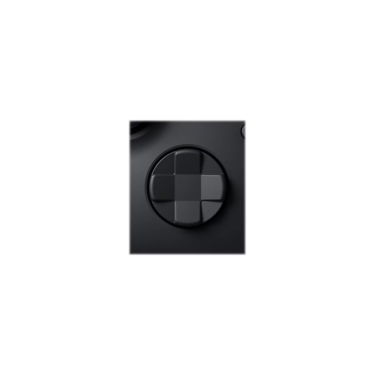 Gros plan sur la croix directionnelle noire d'une manette de jeu. La croix est constituée d'éléments carrés, légèrement surélevés.