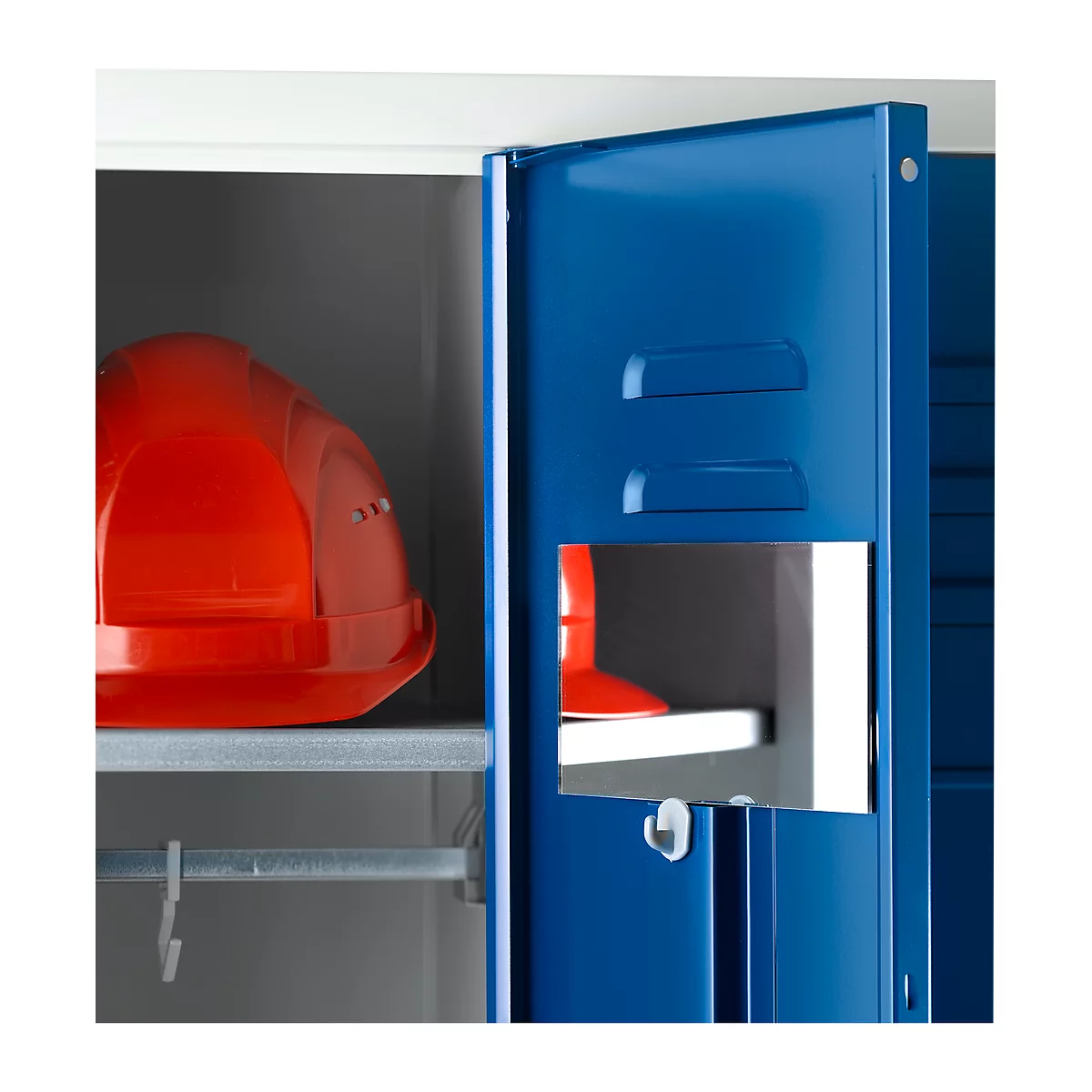 A red safety helmet rests inside a blue locker, which is half-open.