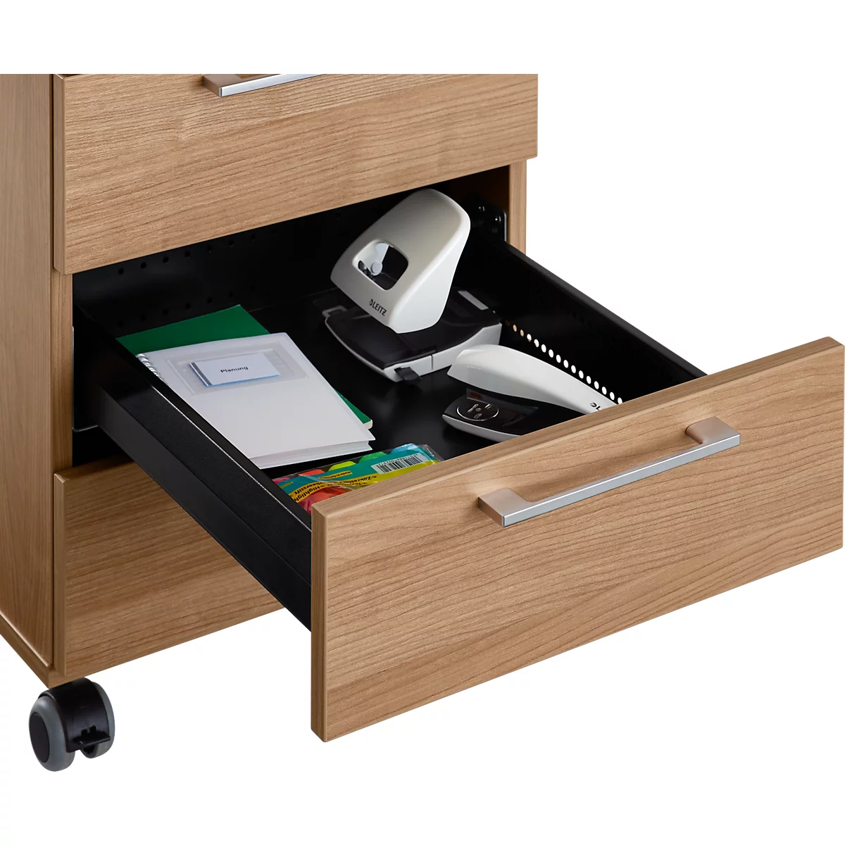 An open wooden desk cabinet. The upper drawer contains folders, papers and office supplies.