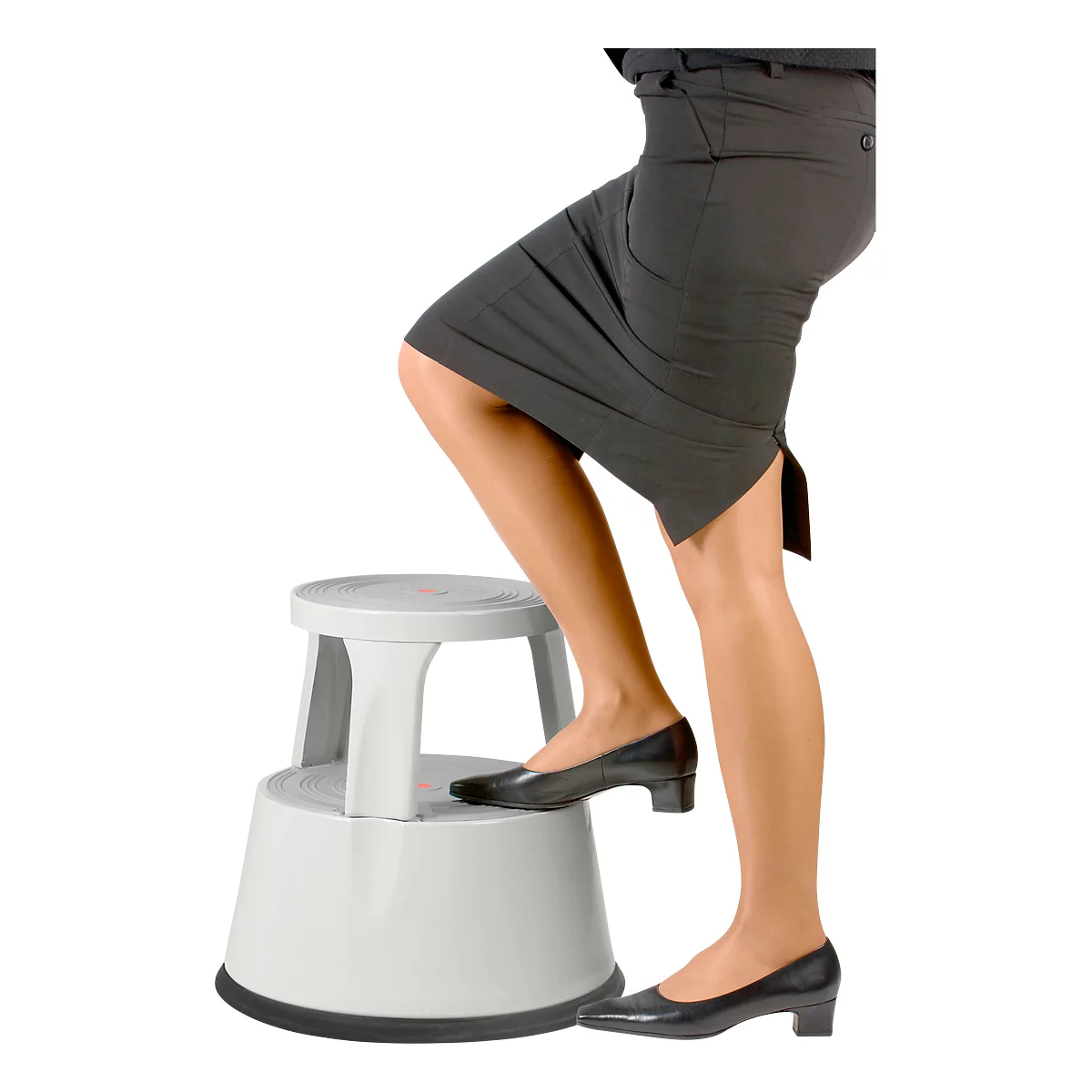 Person steps onto a white step stool. She wears a black skirt and shoes.