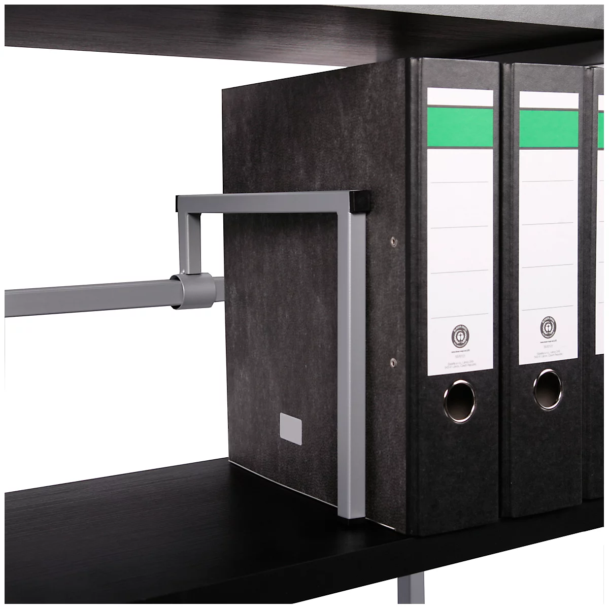 Detail shot: Grey metal frame holding folders on a shelf, black binders with white labels and a green stripe.