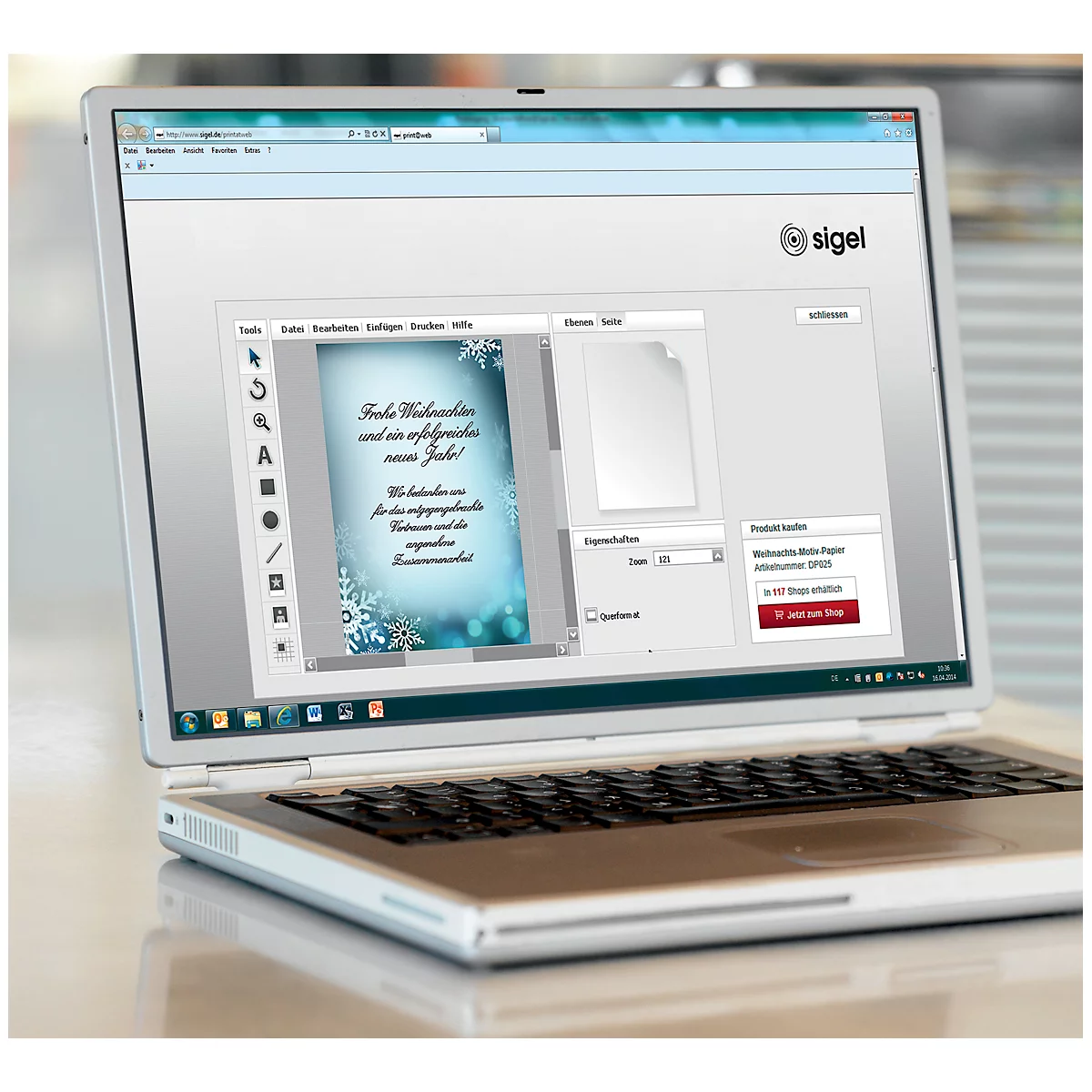 Laptop displaying a Christmas card design website. The text "Merry Christmas and a successful new year!" is visible.