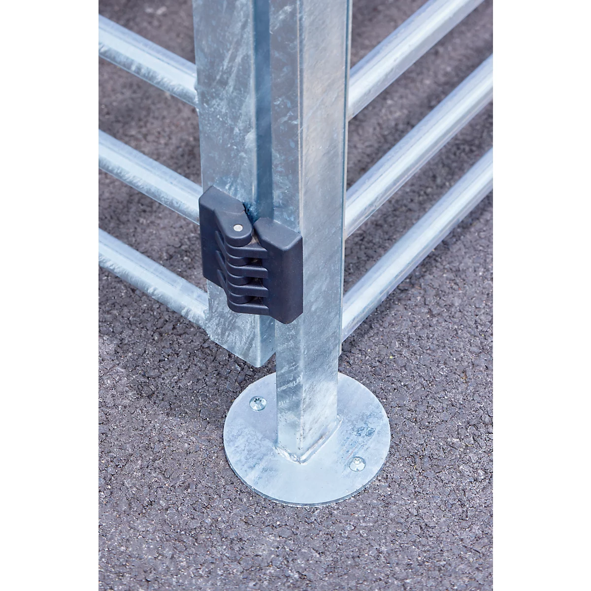 Metal gate with a black locking mechanism, close-up shot.