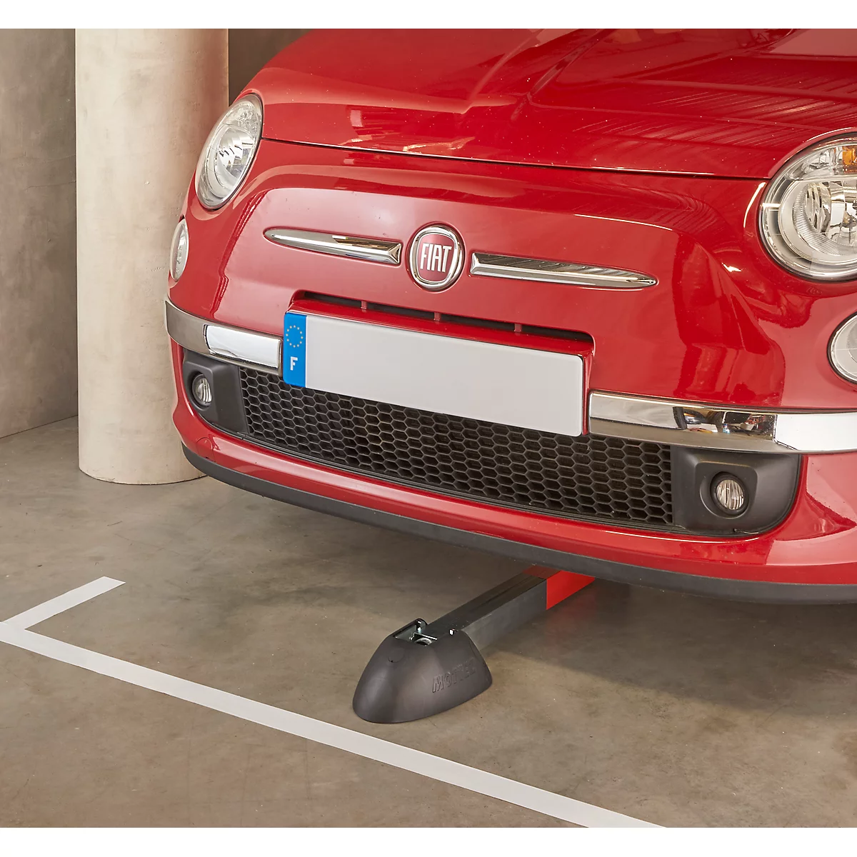 Red Fiat 500 in a parking garage. Front view with license plate, headlights and a vehicle holding system.