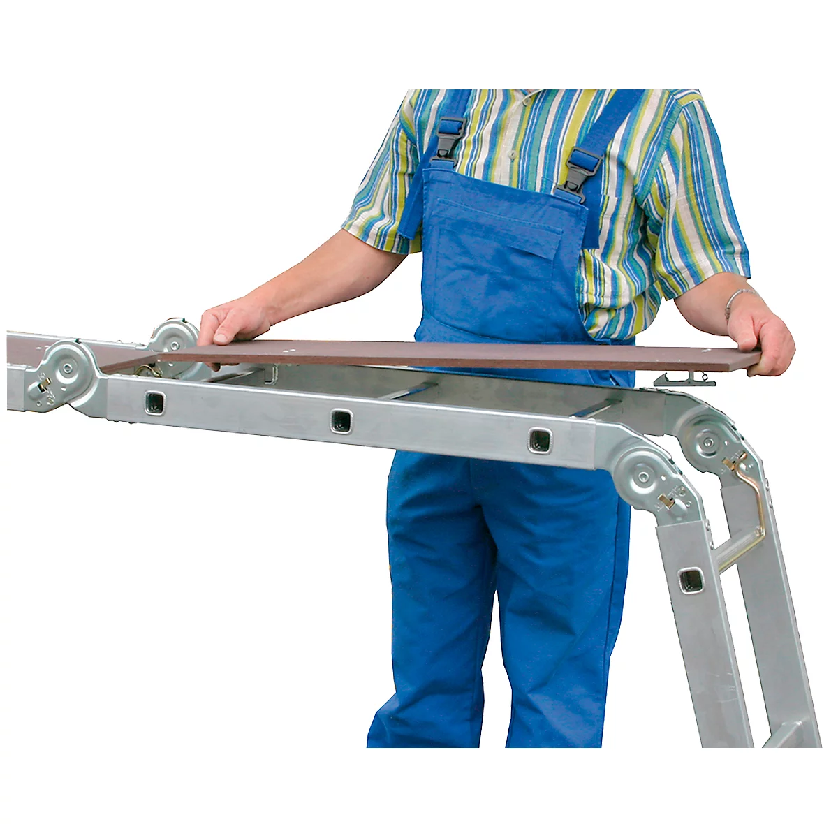 Man in blue overalls holding a brown board over a ladder. The ladder is partially extended.