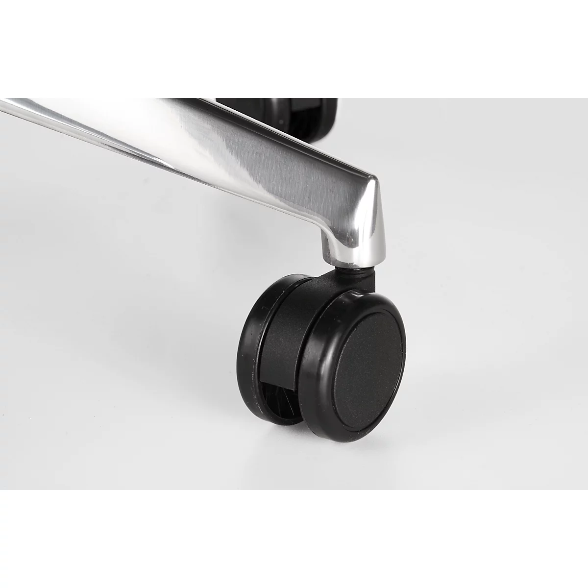 Close-up of a black office chair wheel and a silver leg.