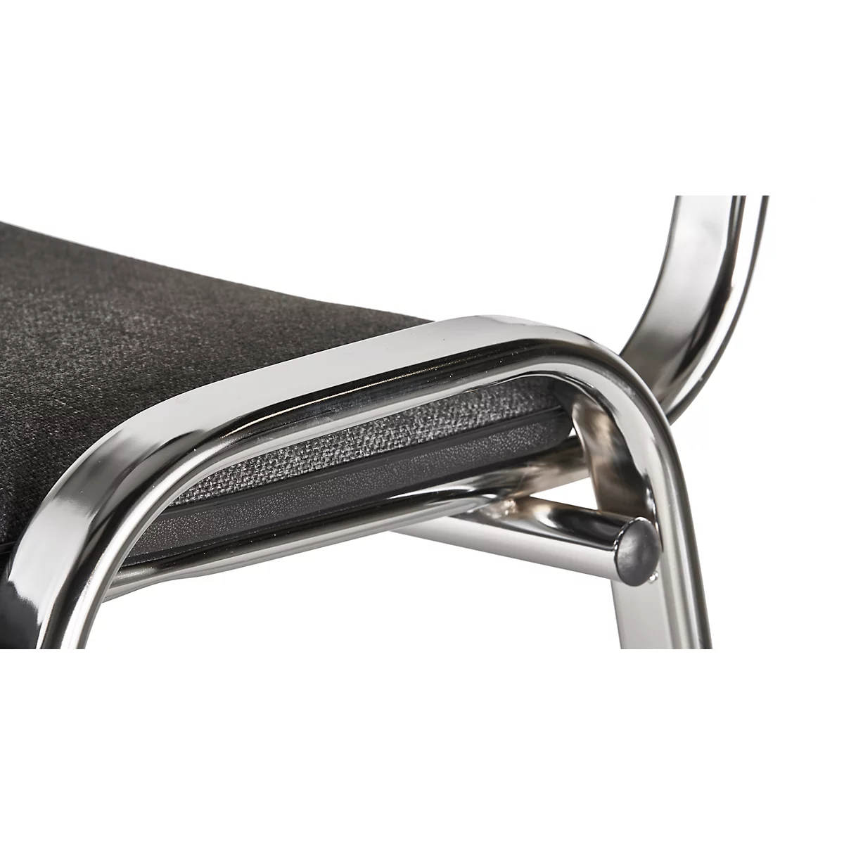 Close-up of a chair. The frame is shiny metal, the seat is gray-black, padded.