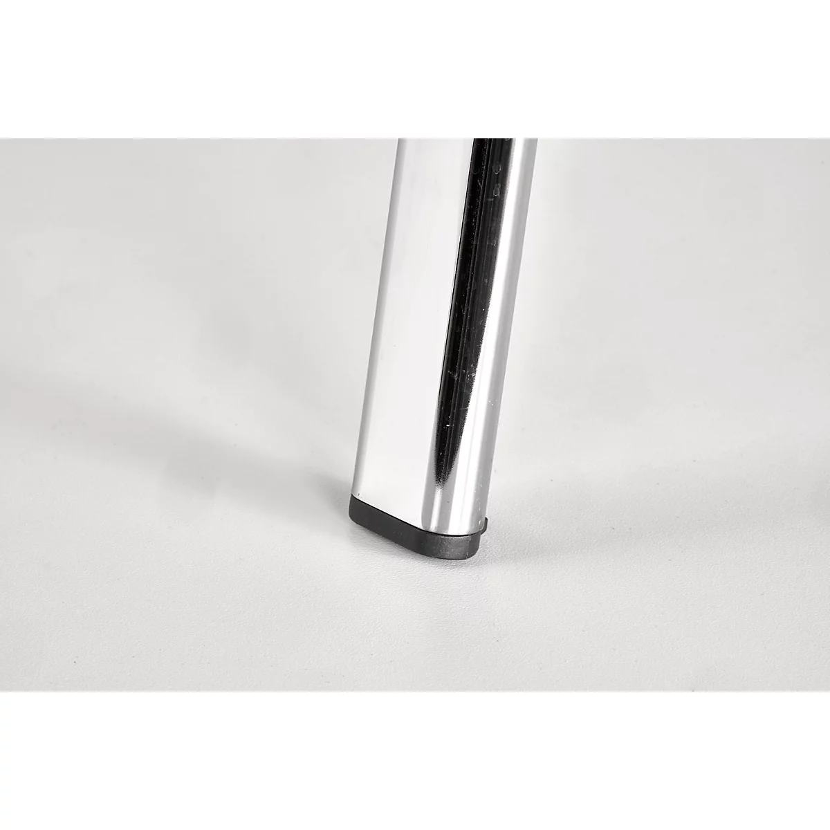 Close-up of a polished metal chair leg. The tip is fitted with a black rubber.