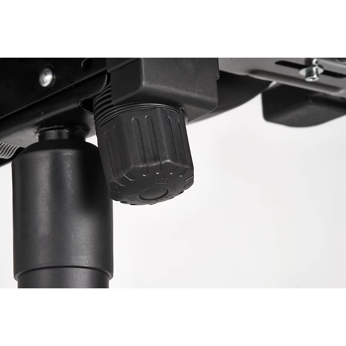 Detail: Black, ribbed adjustment knob under a metallic chair frame, set against a bright background.