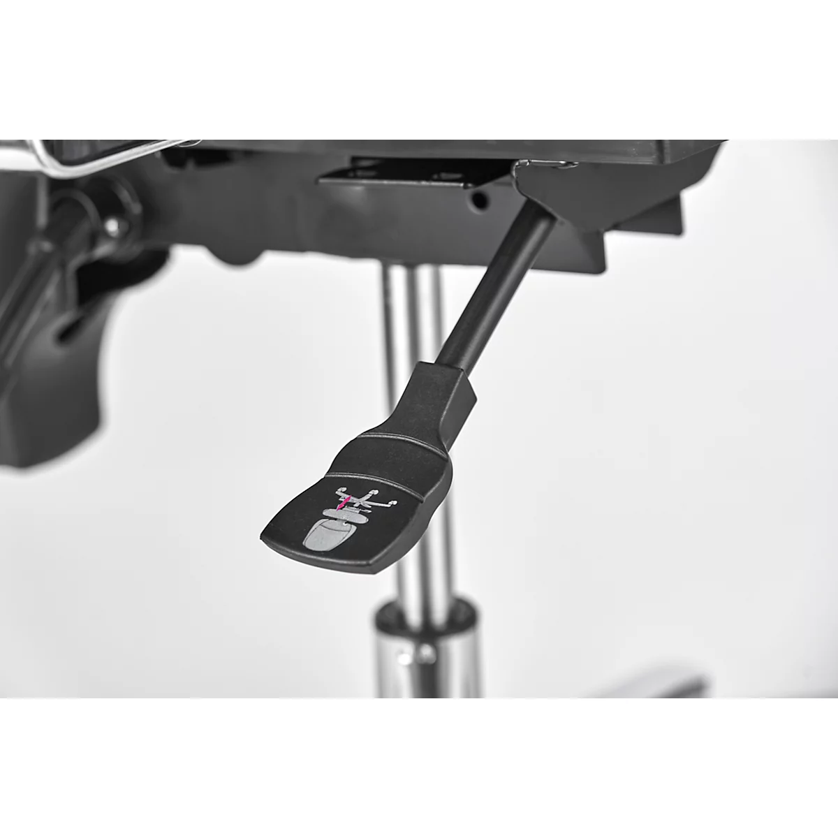 Detail of a black chair lever with a symbol. The detail shows the symbol and mechanics of the chair.