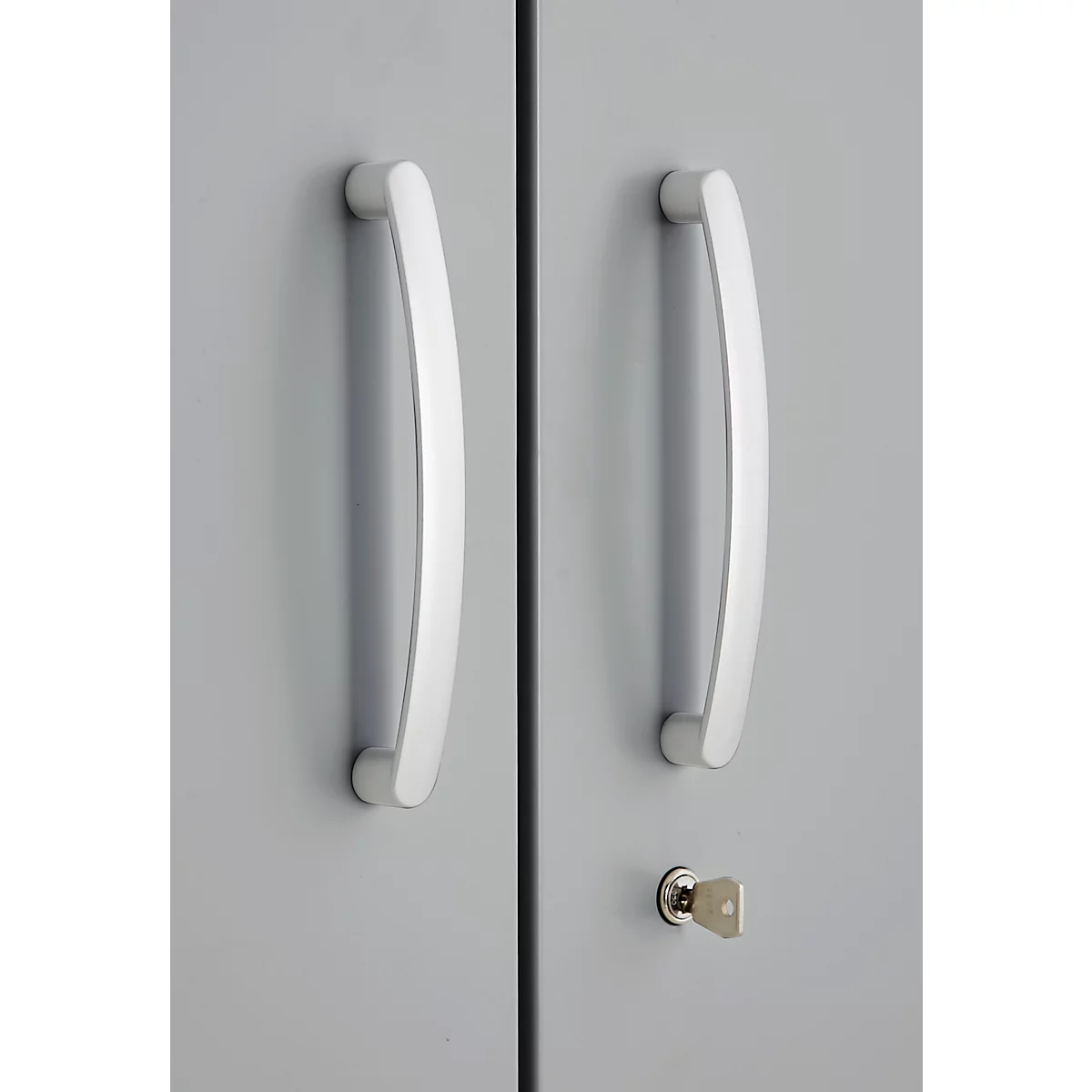 Grey cabinet doors with silver handles. A key is in the keyhole.