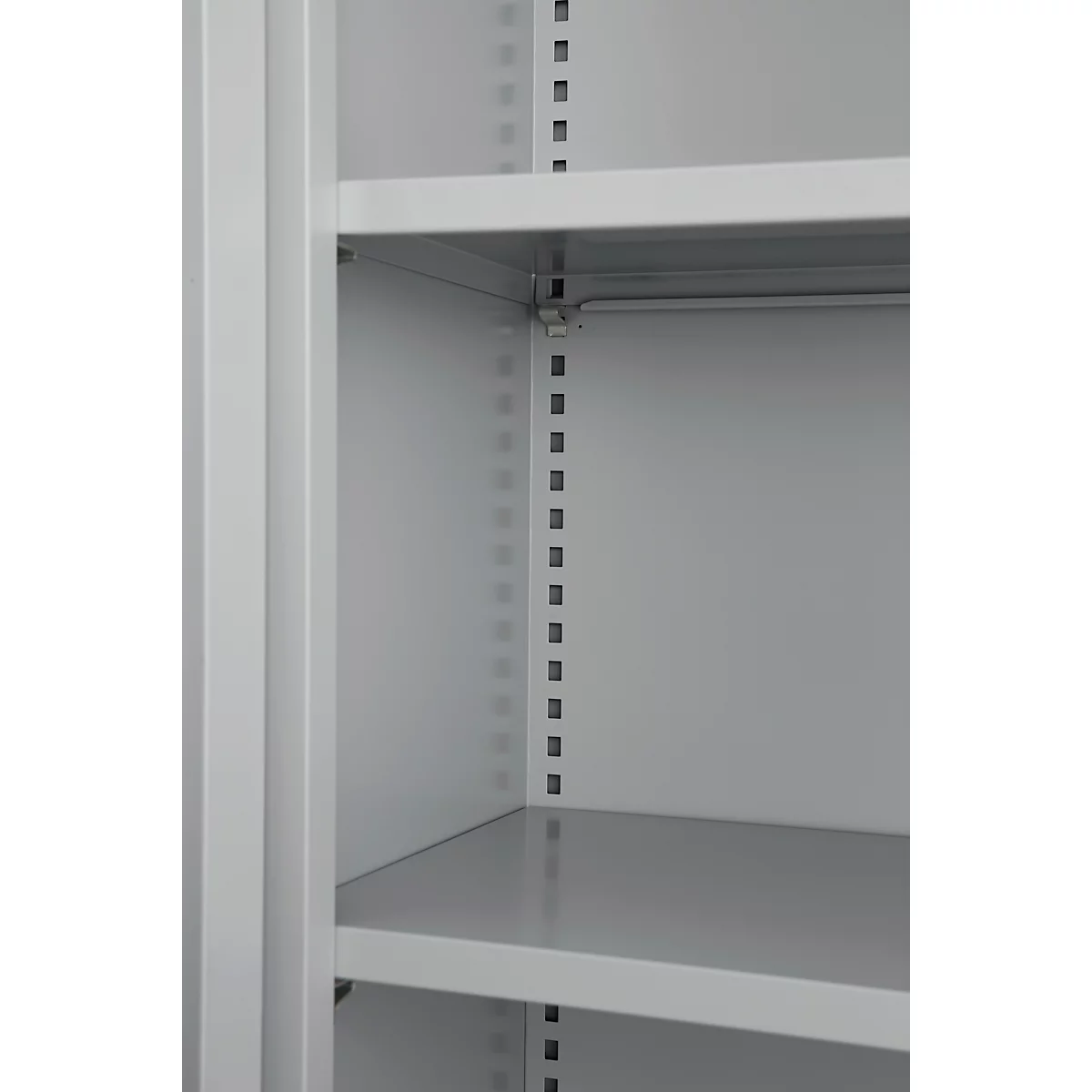 Close-up of the interior of a grey cabinet with shelves and a vertical metal strip with holes.