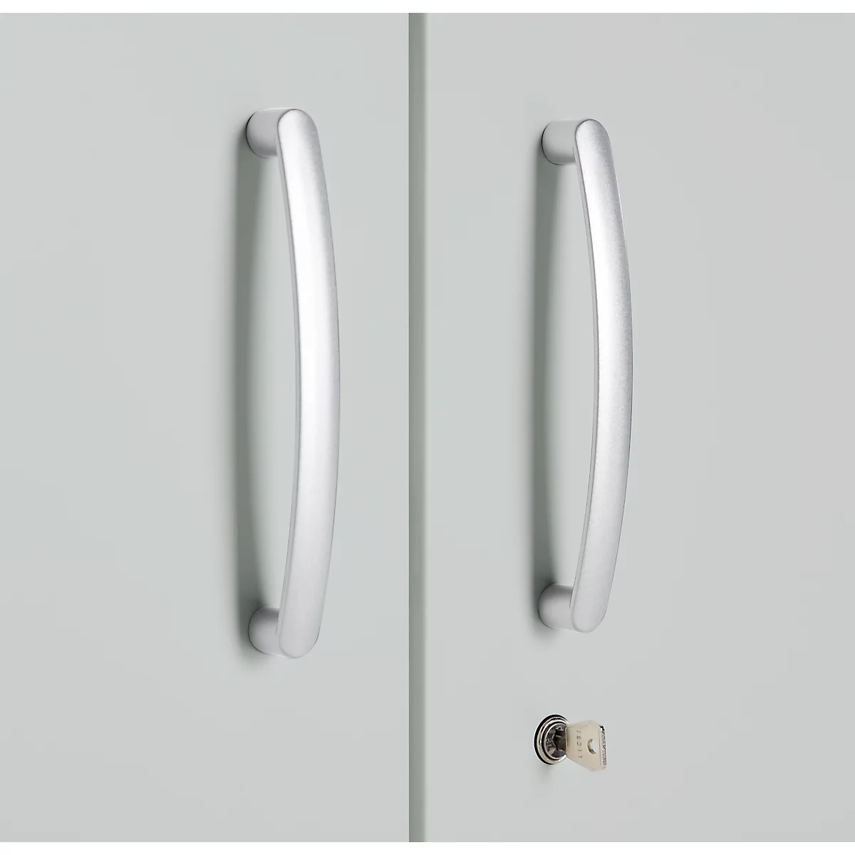 Two silver handles on a gray cabinet door, next to it a keyhole with a key.