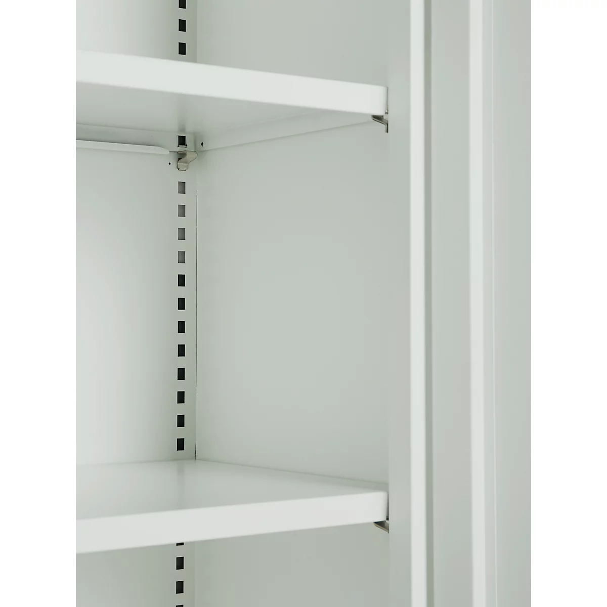 Close-up of a light gray cabinet interior with two shelves. The cabinet wall can be seen between the shelves.