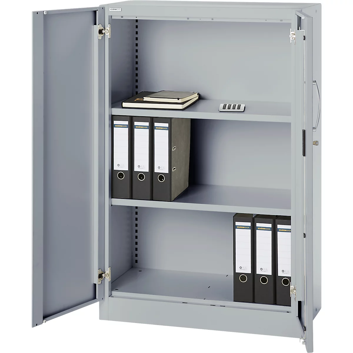 Gray steel cabinet with open door. Folders, notebook and a calculator lie on the shelves.