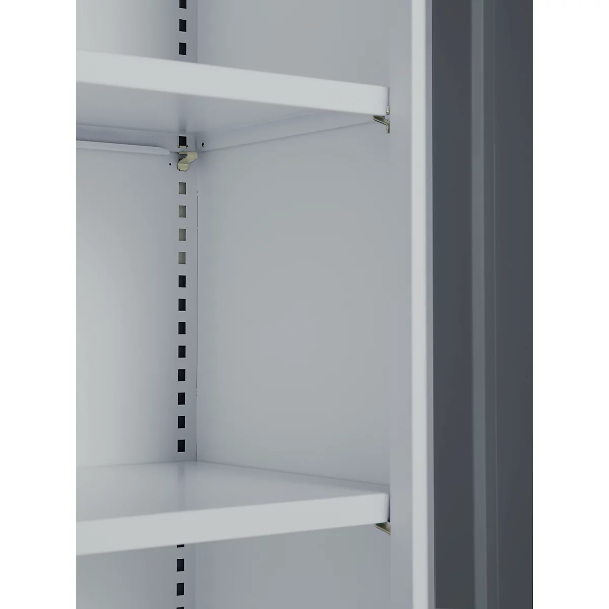 Interior view of a white cabinet with shelves. The individual shelves are height-adjustable, as can be seen by a series of holes, which serve to hang the shelves.