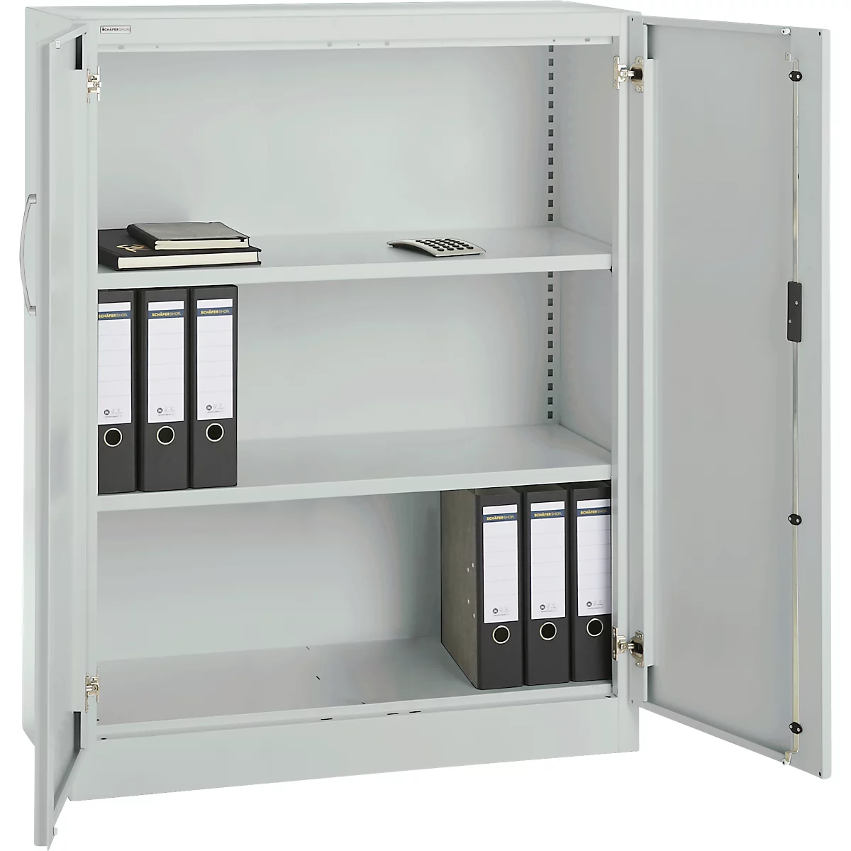 Grey filing cabinet with open door. File folders, notebooks and a calculator are in the cabinet.