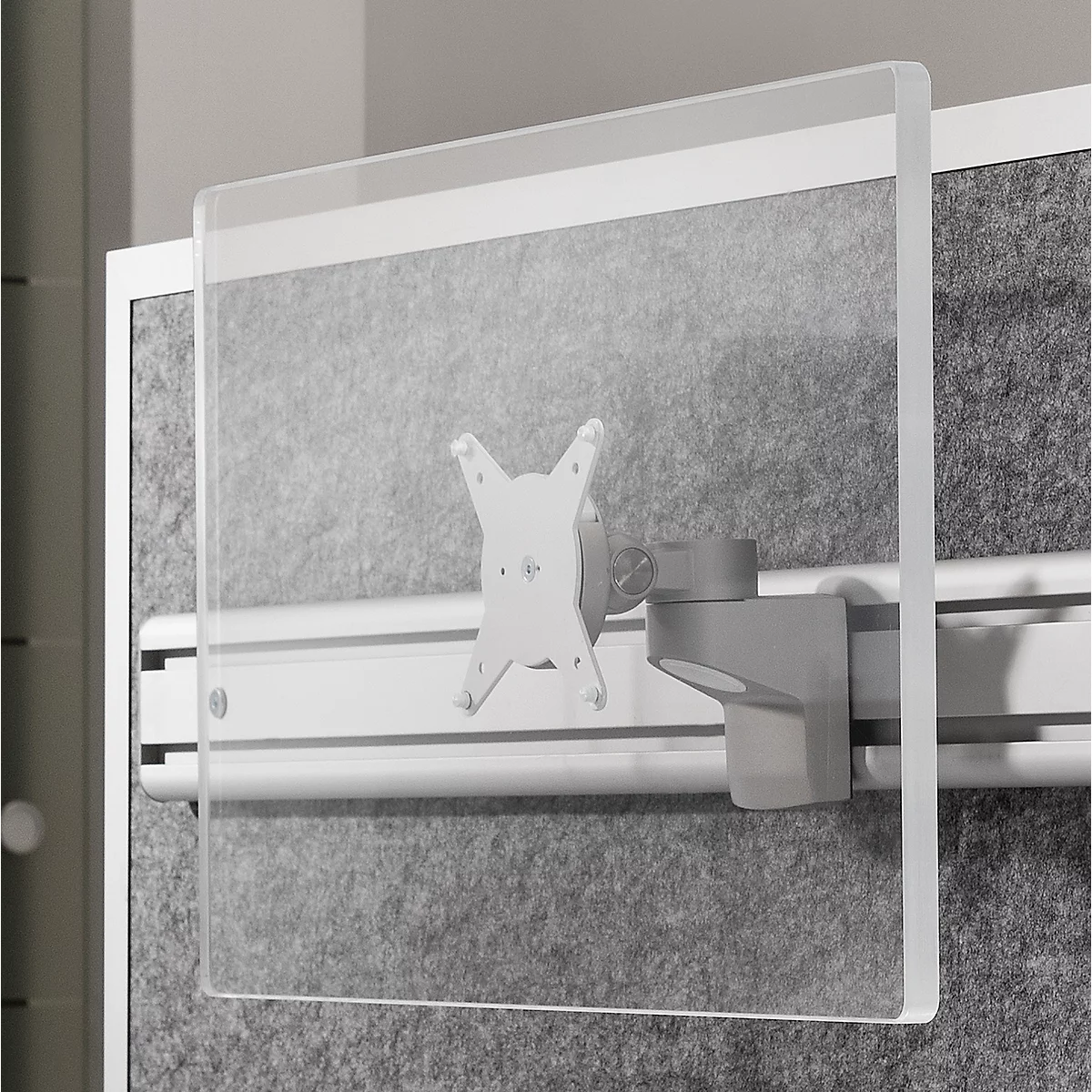 Transparent partition mounted with bracket on gray wall.