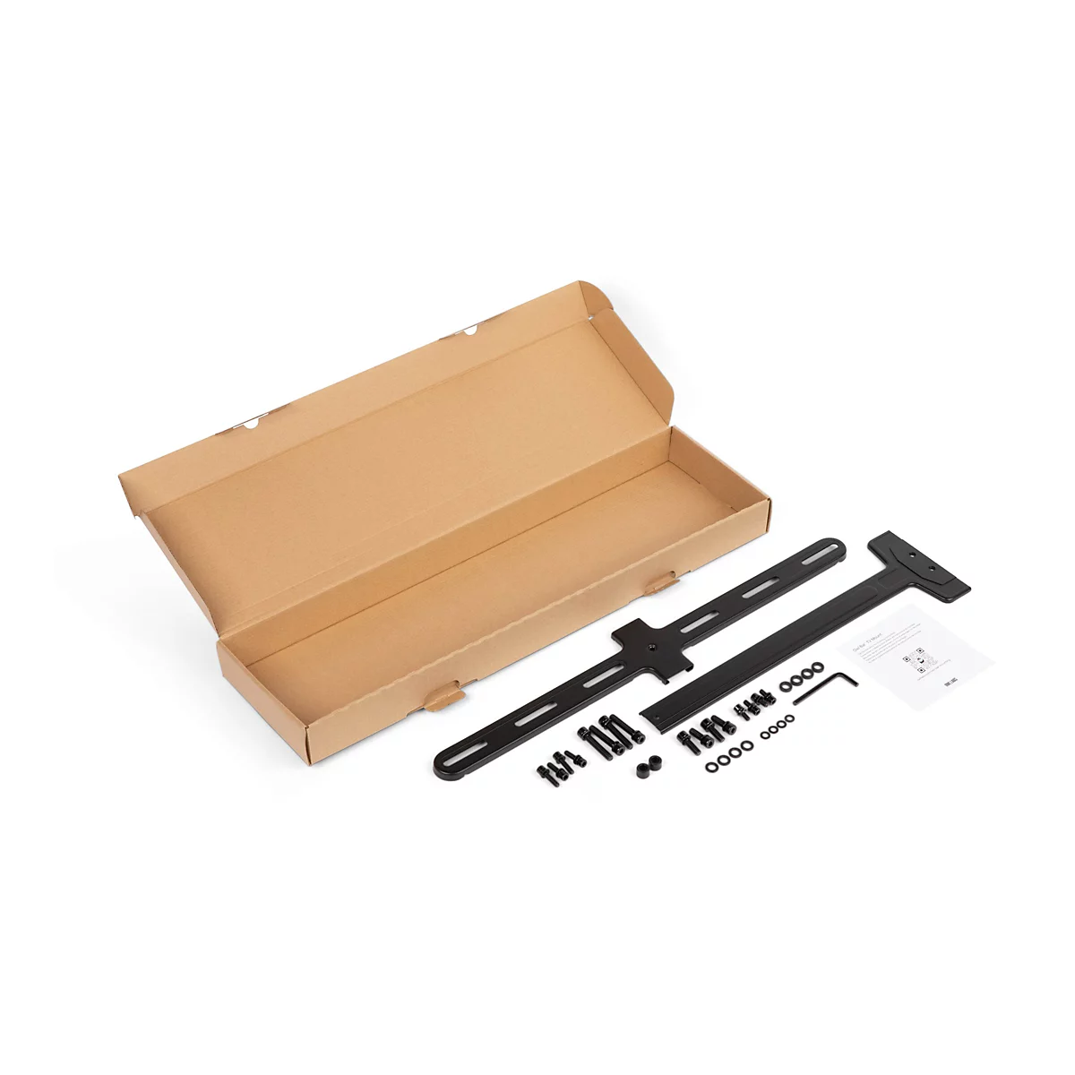Boîte brune ouverte avec matériel de montage noir pour une TV : rails, supports, vis, clé Allen et instructions.