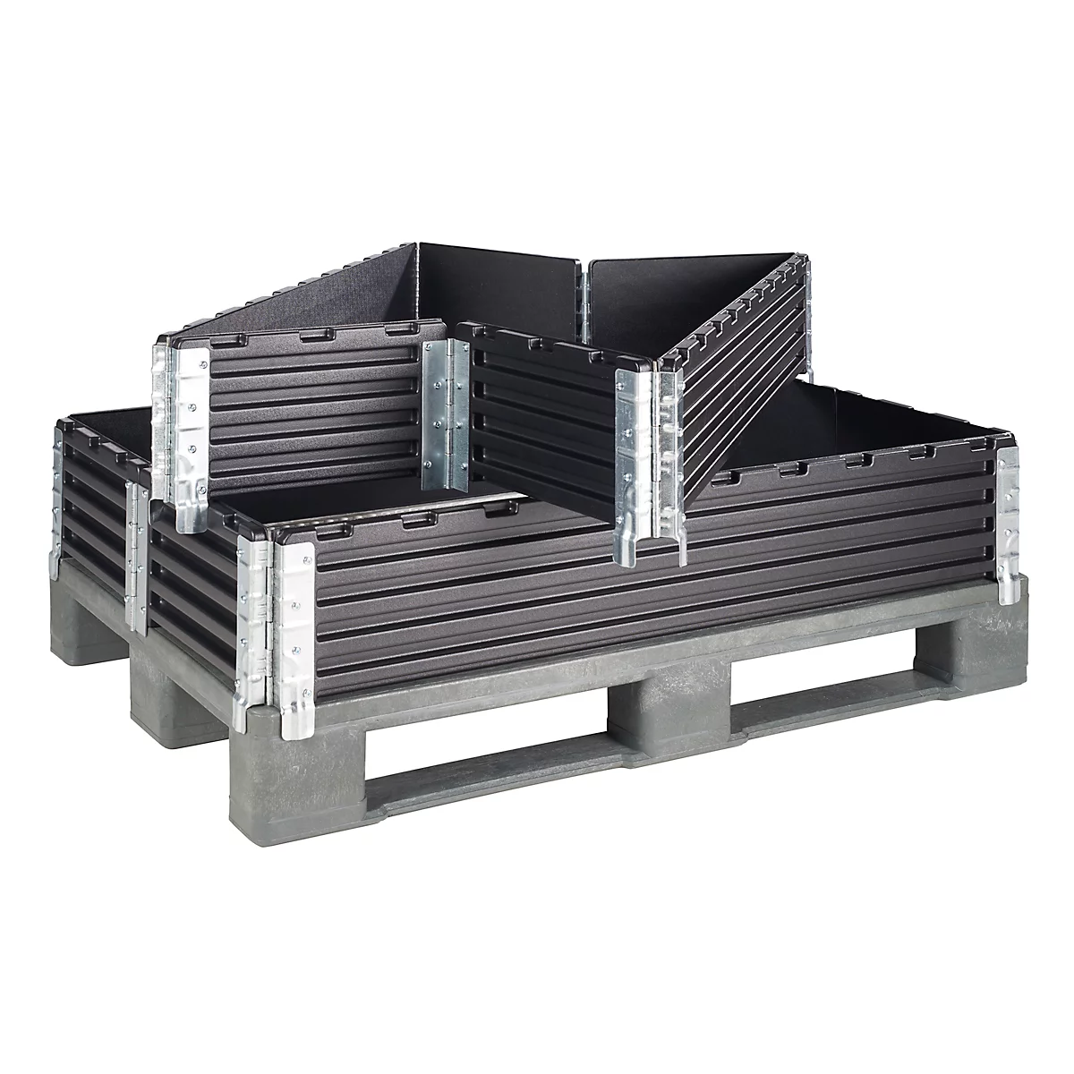 Black, foldable boxes, partially open, on a gray pallet. Metal hinges connect the boxes.
