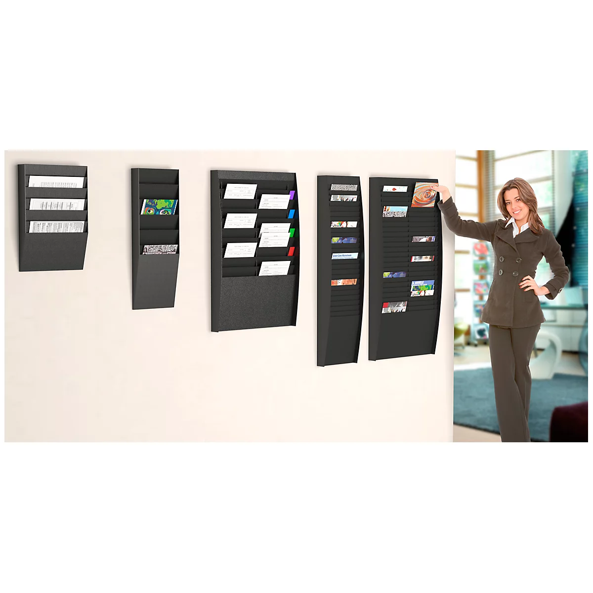 Three black wall holders with a woman in a suit in an office. One holder is being touched by the woman.