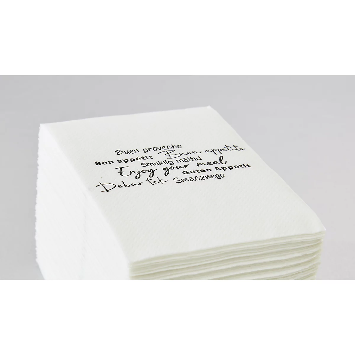Pile de serviettes blanches avec l'impression : "Enjoy your meal" dans différentes langues.