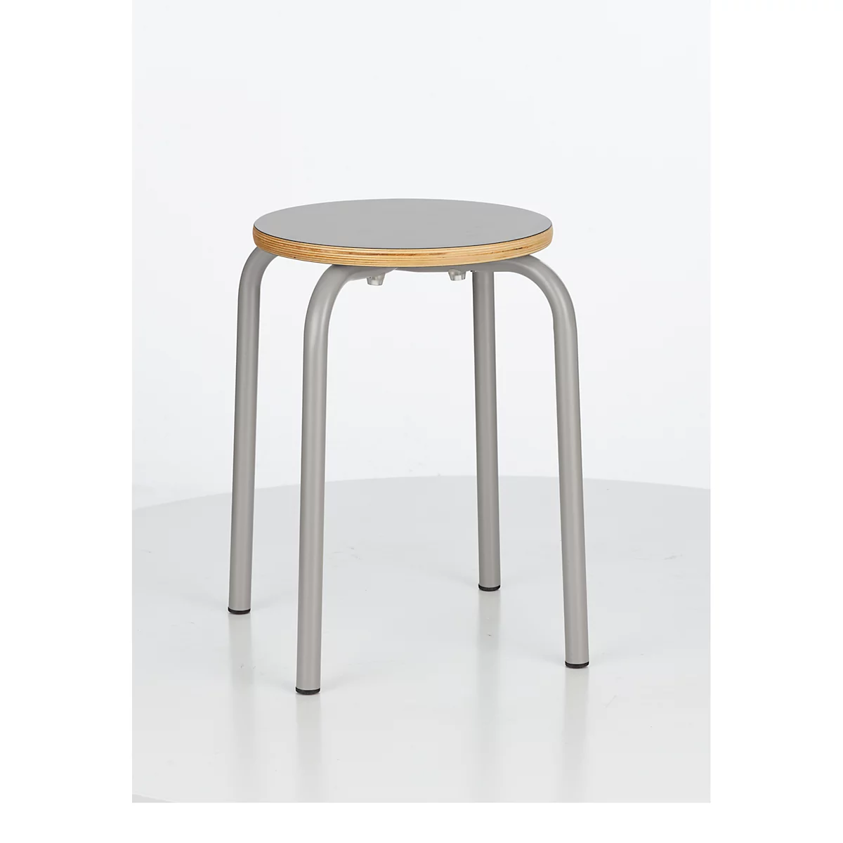 Grey stool with a round seat on a white background.