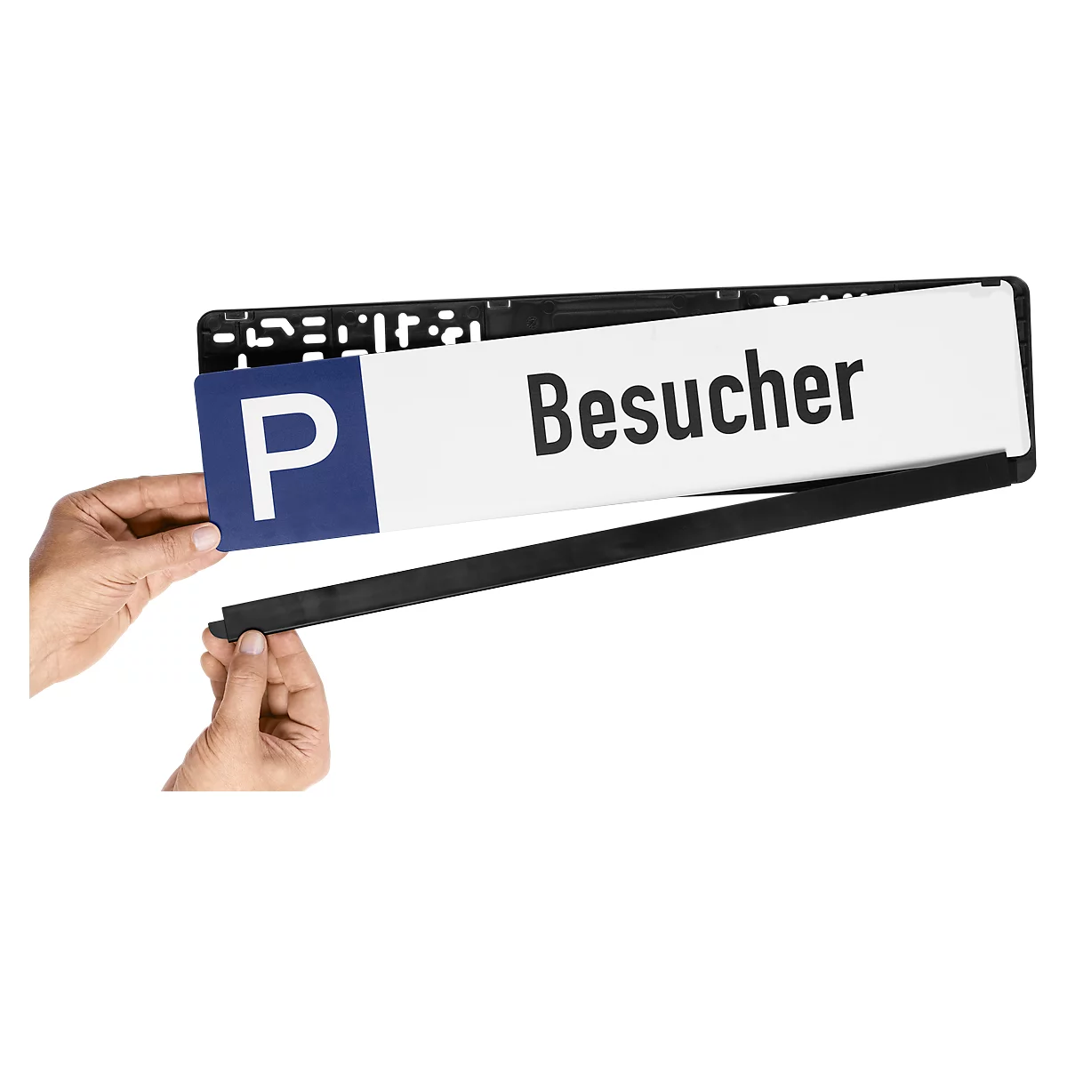 Person holding a license plate with "Besucher" and the blue "P" symbol. Black frame.