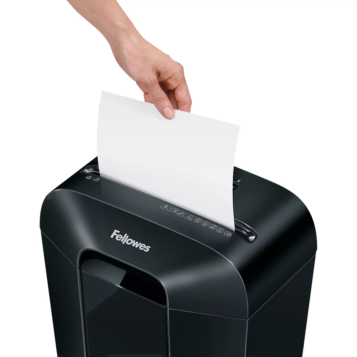 A hand placing a sheet of paper into a black Fellowes paper shredder.